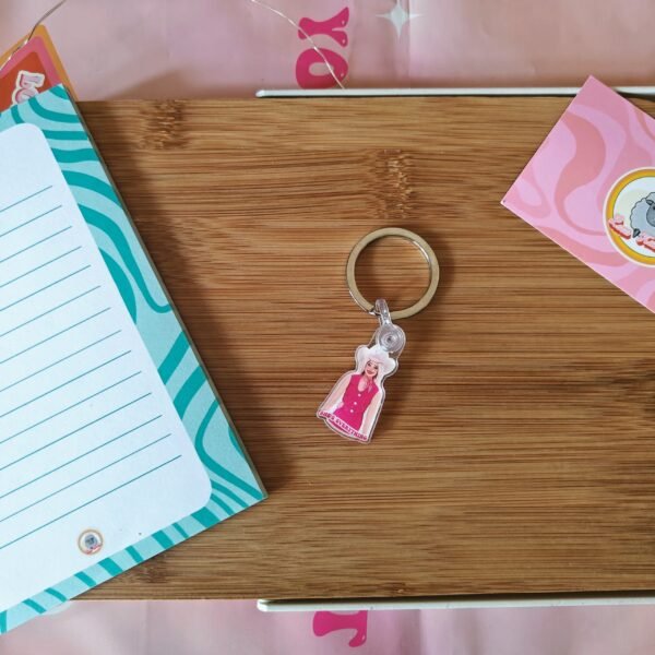 A cute Barbie 'She's Everything' quote keyring with durable silver hardware, perfect for accessorising your bags and keys.
