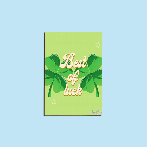 "Best of Luck" greeting card with four-leaf clovers on a green background.