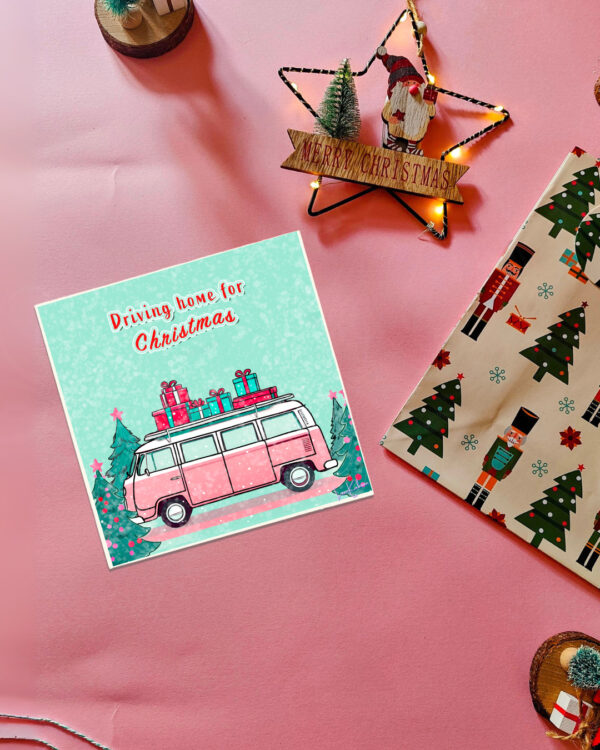 Driving Home for Christmas card featuring a pink retro VW van carrying gifts with a festive winter background.