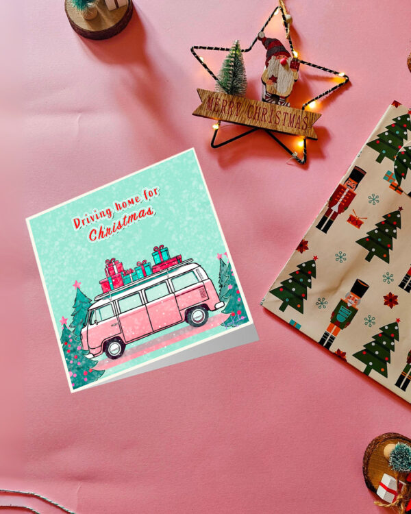 Driving Home for Christmas card featuring a pink retro VW van carrying gifts with a festive winter background.