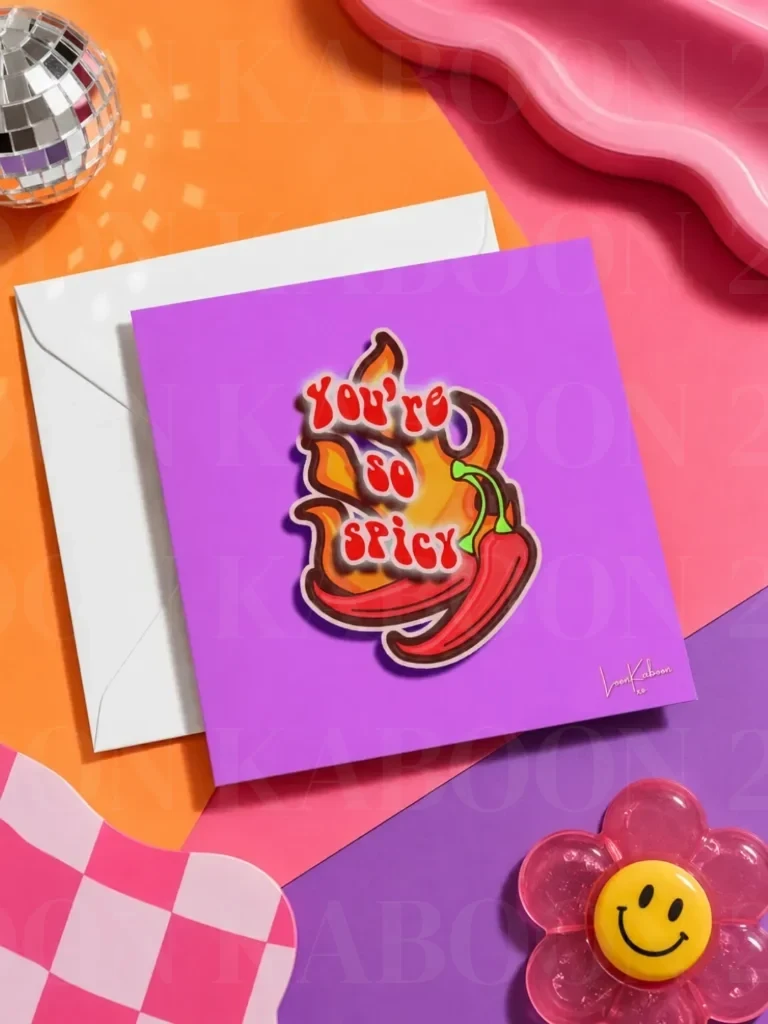'You're So Spicy' Greeting Card flat lay on funky colourful table.