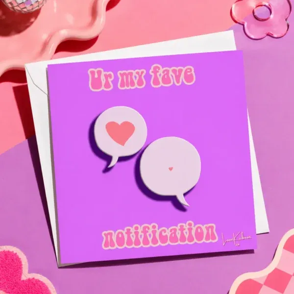 My Fave Notification card flat lay on colourful table.