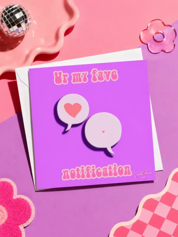 My Fave Notification card flat lay on colourful table.