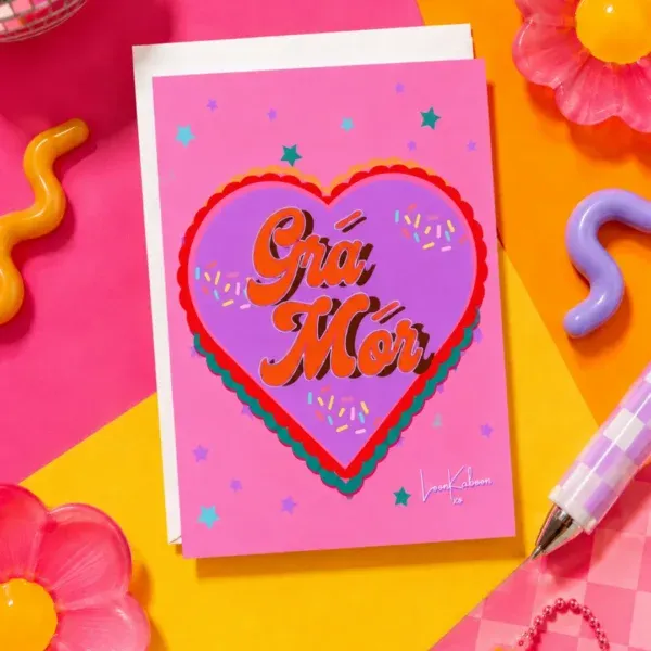 Grá Mór Card flat lay against funky colourful table
