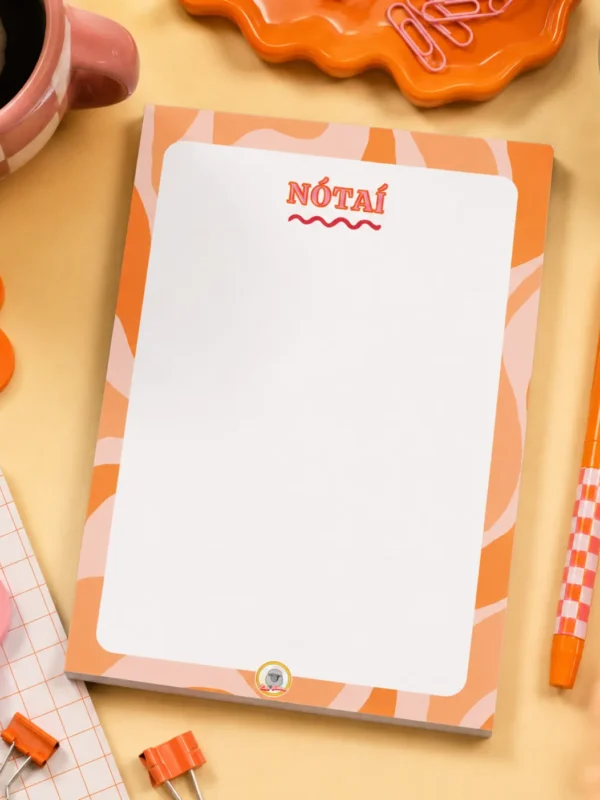 Nótaí A5 Notepad on a funky desk with pens, paperclips and other desk items.