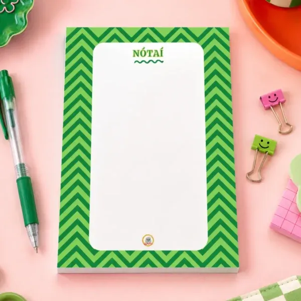 Nótaî Chevron A6 Notepad on a funky desk with pens, paperclips and other desk items.