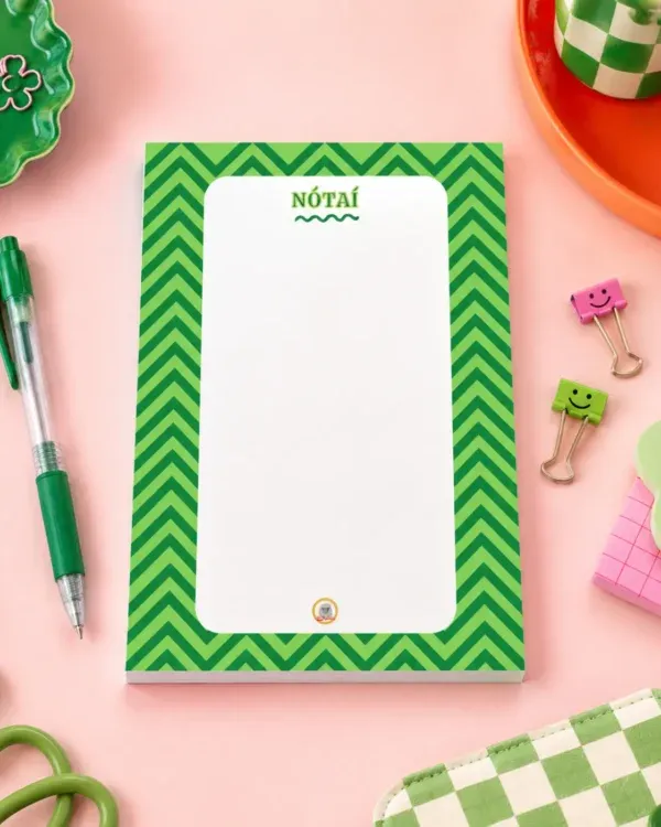 Nótaî Chevron A6 Notepad on a funky desk with pens, paperclips and other desk items.