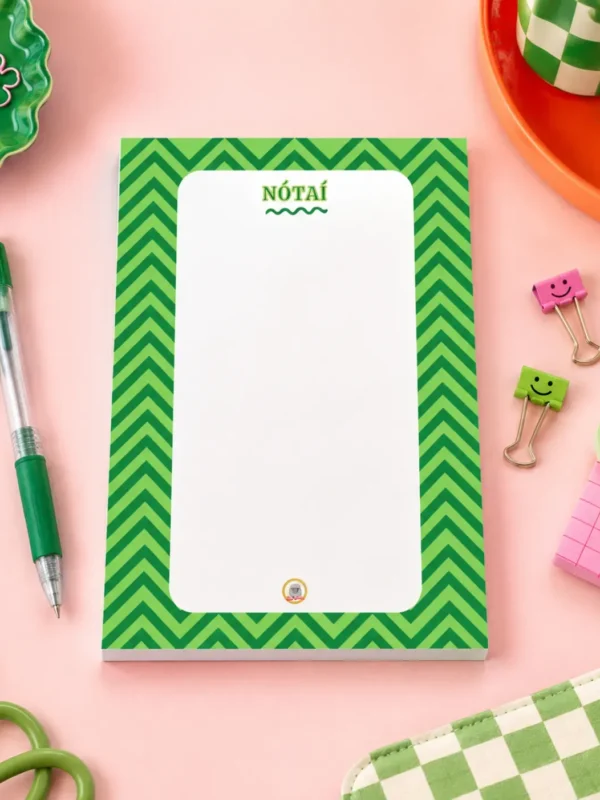 Nótaî Chevron A6 Notepad on a funky desk with pens, paperclips and other desk items.