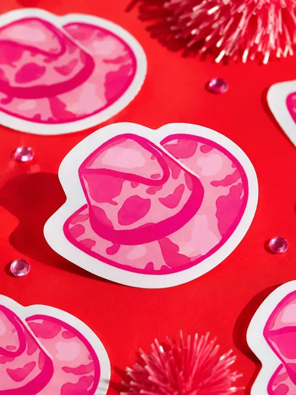 Pink Cowpal Hat Sticker on funky red background with tinsel.