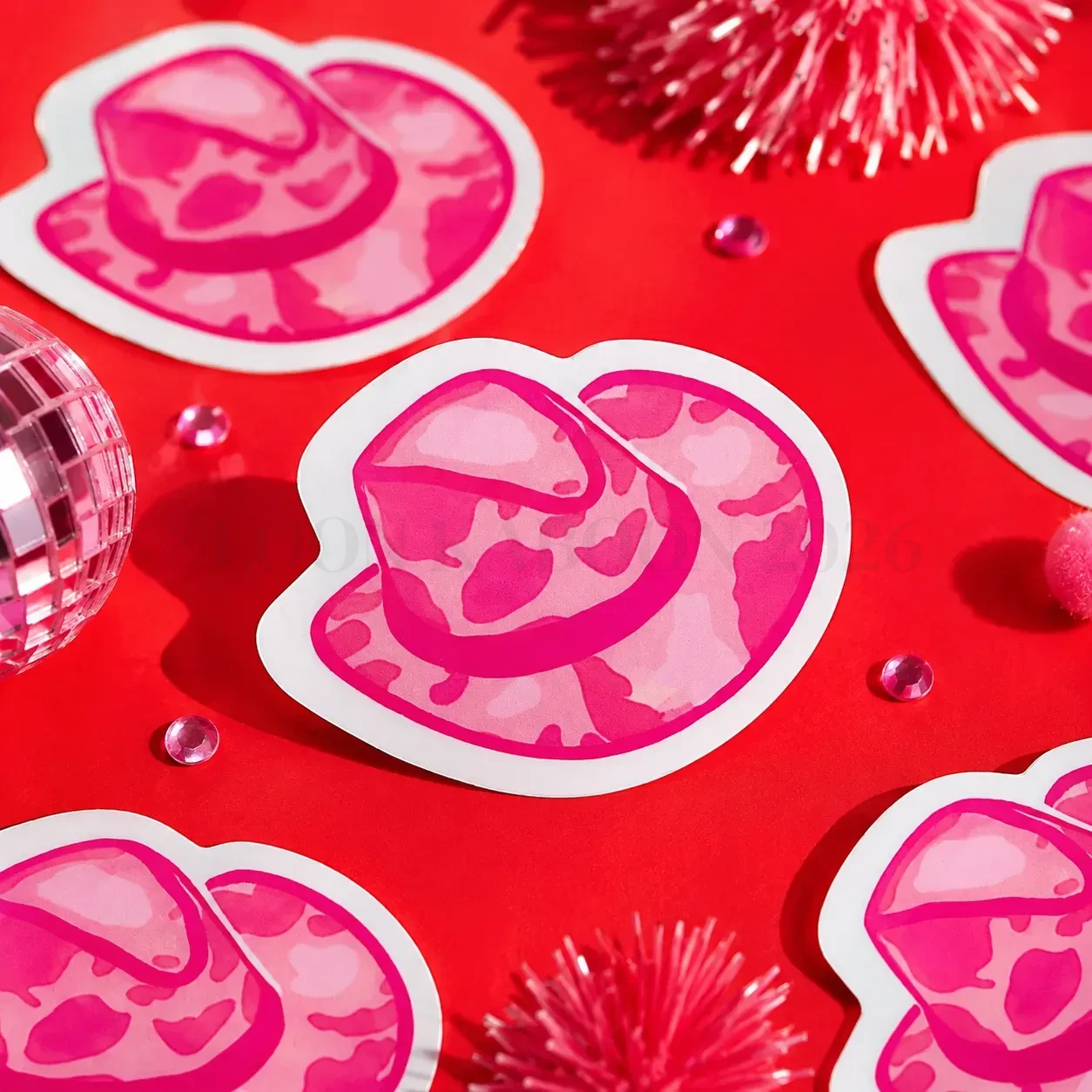 Pink Cowpal Hat Sticker on funky red background with tinsel.