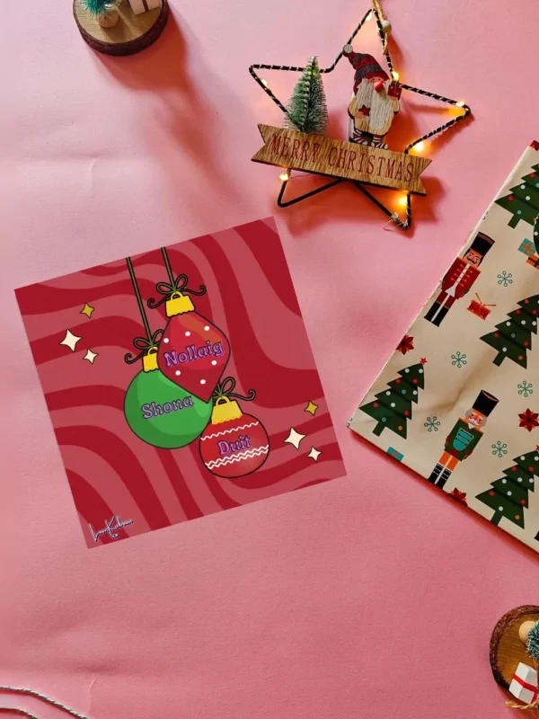Nollaig Shona Duit Card Flatlay Nollaig Shona Duit Irish Christmas card with bauble illustrations by Loon Kaboon